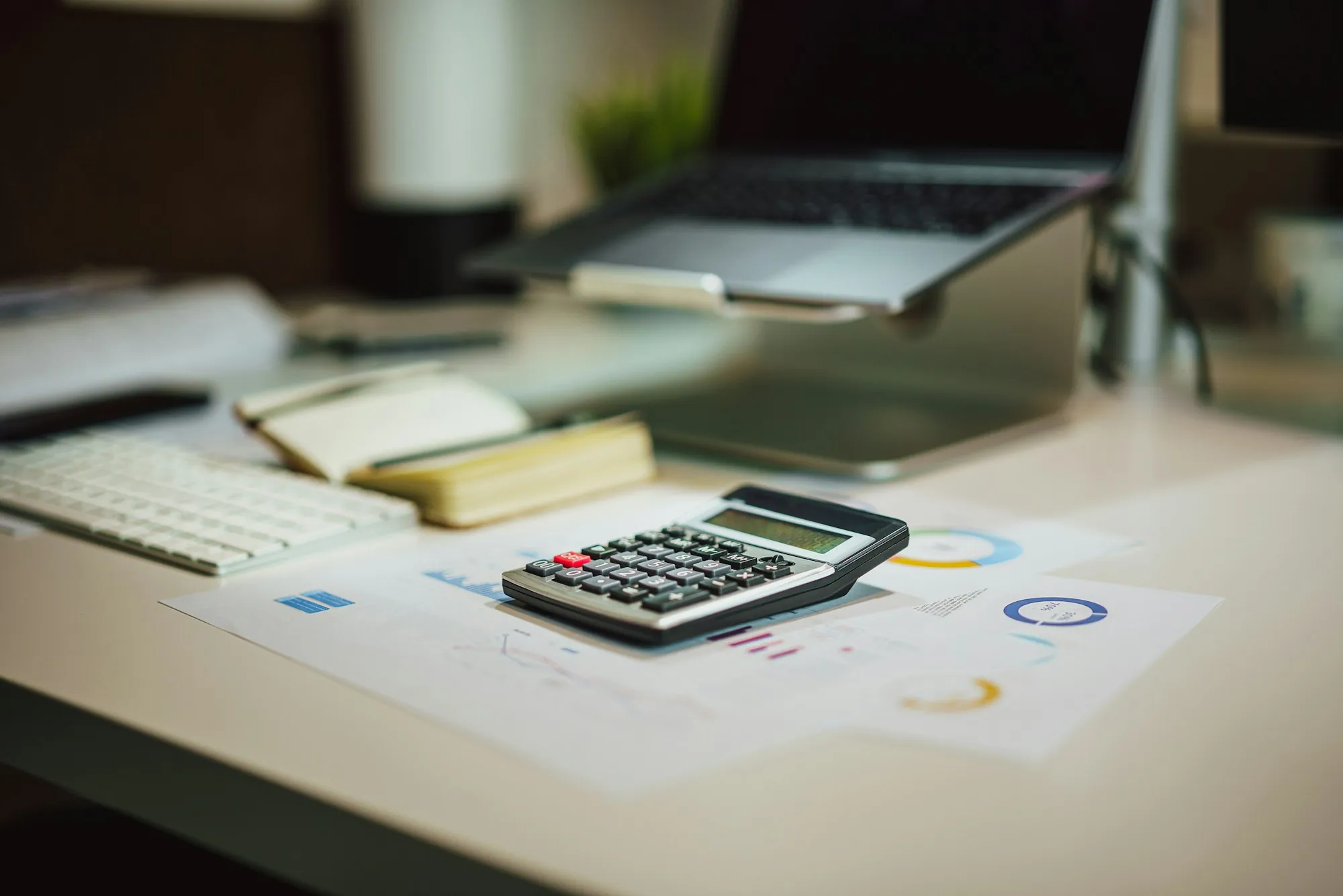 A calculator and paperwork on a desk